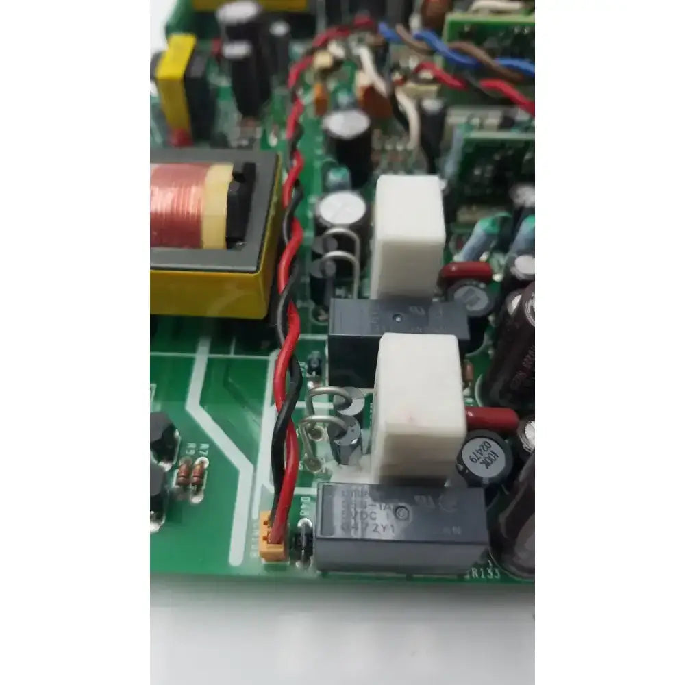 Black rectangular relay with white labeling and silver contacts on green nayuta nb497 spu-10 power supply control board