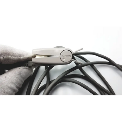 A sleek light gray metal cable organizer with circular emblem and slots for managing black spo2 adapter cable compatible cables