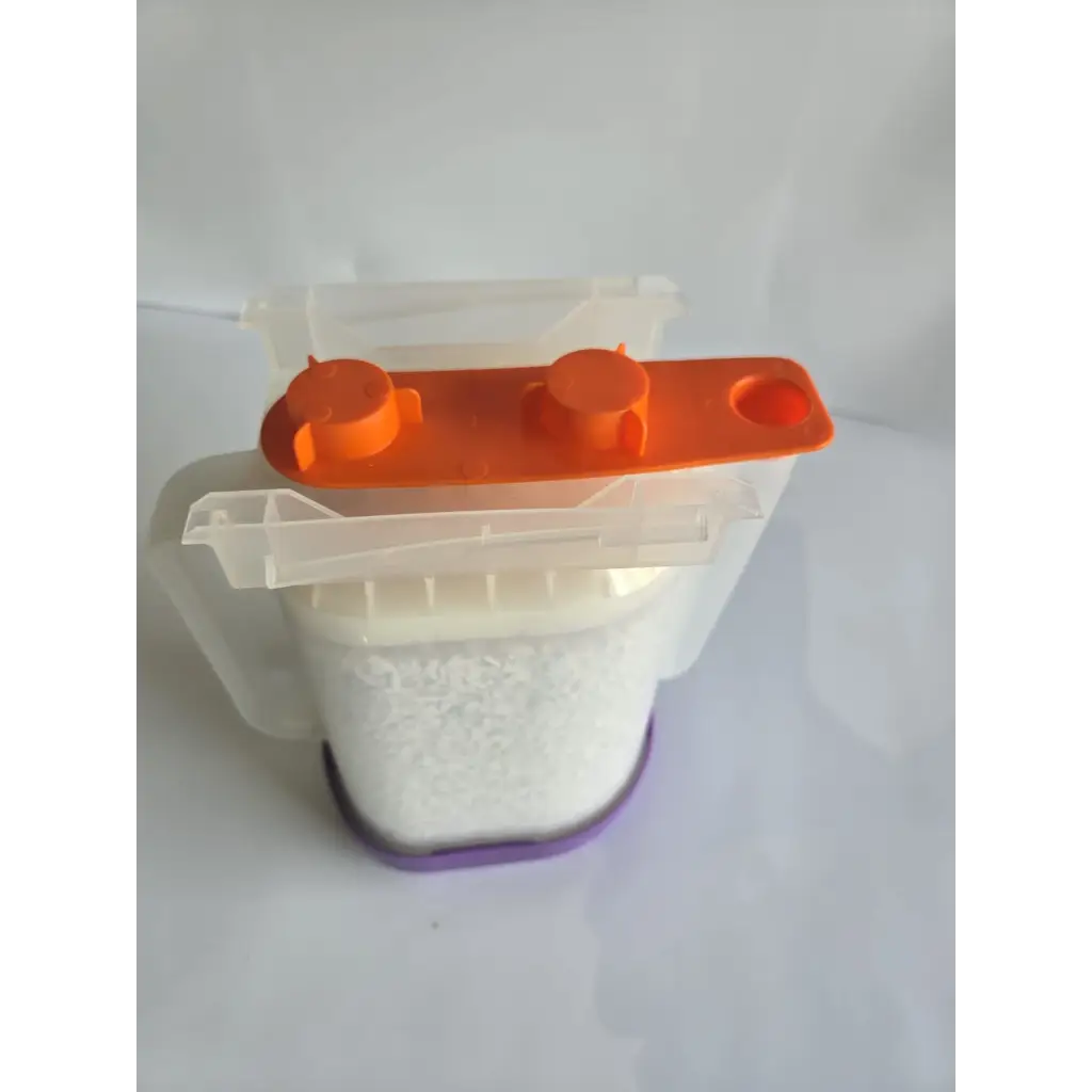 Transparent plastic healthcare zplege-01 absorbent granules dispenser with orange lid and purple base filled with white powder