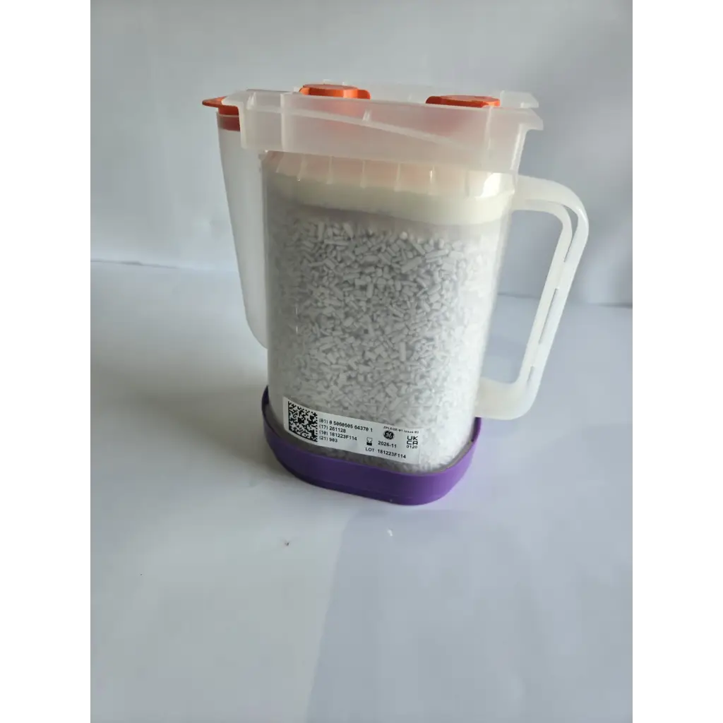 Transparent plastic measuring jug with orange caps and white handle filled with healthcare zplege-01 absorbent granules
