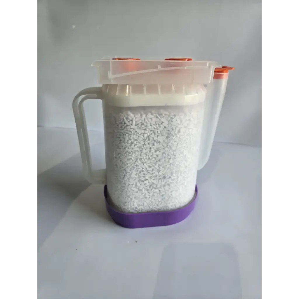 Clear plastic pitcher with orange spout caps and purple base filled with healthcare zplege-01 absorbent granules