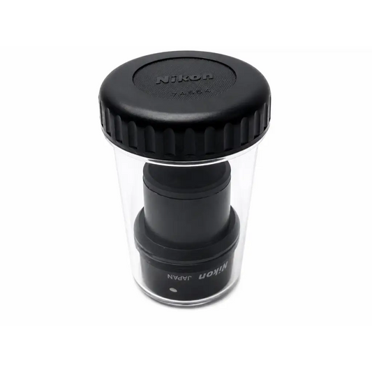 Black nikon cfi 15x macro lens with textured cap in clear protective case for medical equipment use
