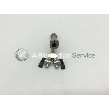 Silver olympus a20977a horn bridge adapter with black handles and central cylindrical body featuring dual stopcocks