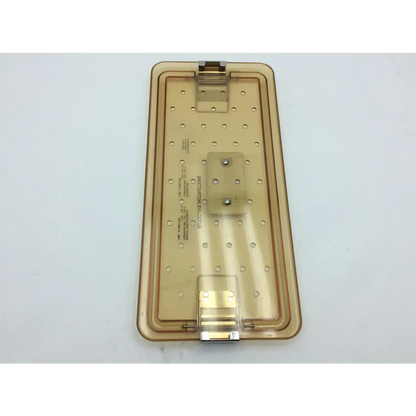 Transparent amber-colored plastic olympus autoclave instrument tray with hinged lid and circular indentations for sterilization