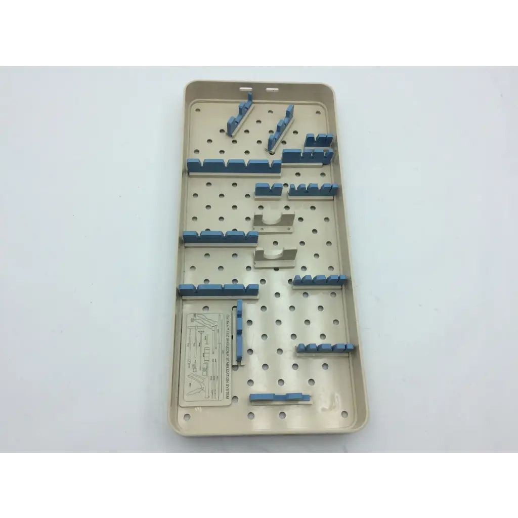 Beige plastic olympus autoclave instrument tray with blue and metallic components in organized slots for sterilization