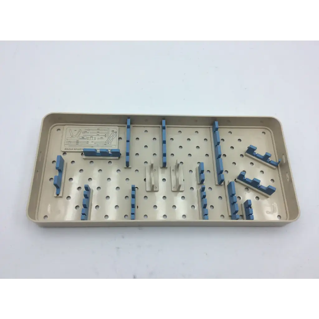 Beige plastic olympus autoclave instrument tray with blue and silver metal holders for surgical instruments