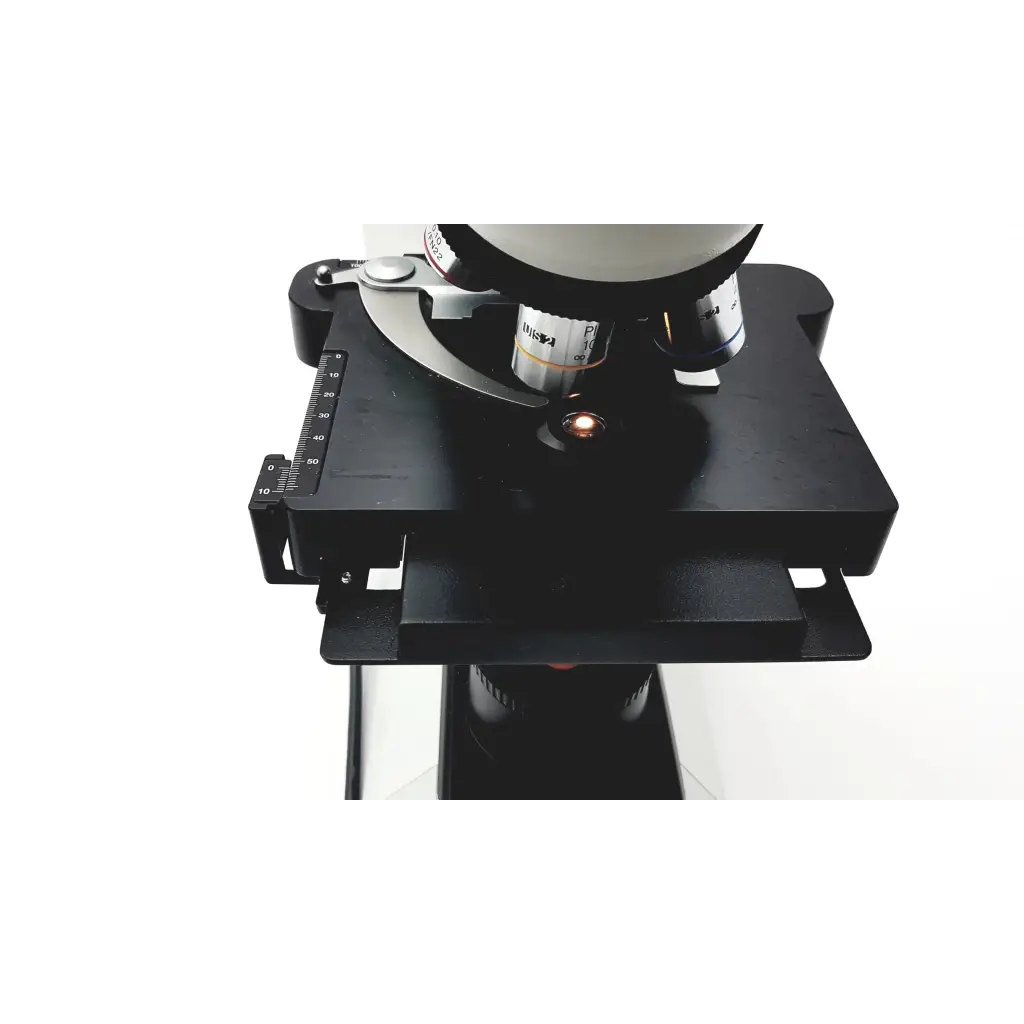 Black metal microscope stage with adjustable height and measurement markings on olympus cx41rf microscope