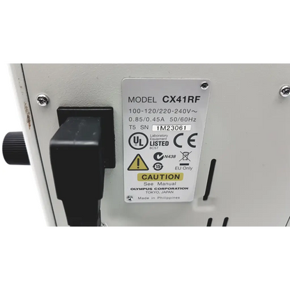 White olympus cx41rf microscope showing black power switch and certification label on laboratory equipment