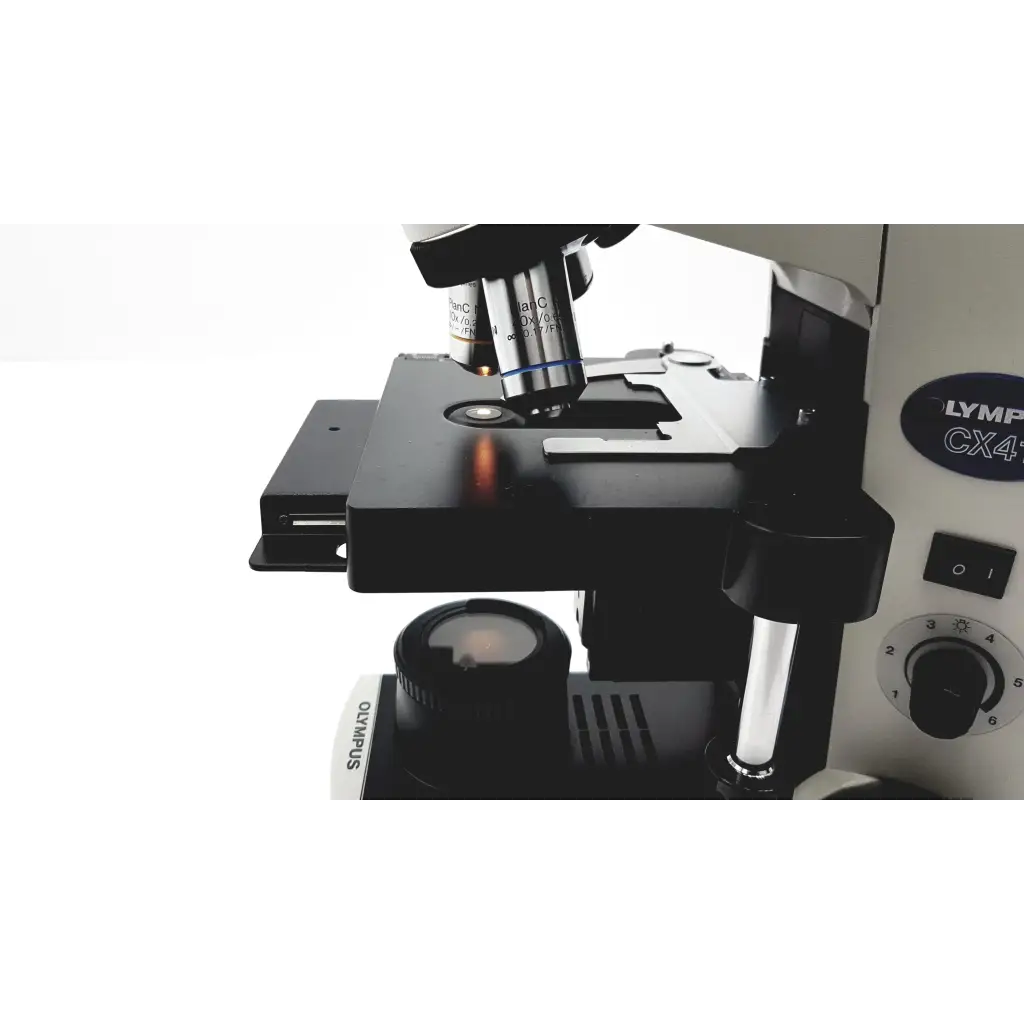 Black and silver olympus cx41rf microscope with rotating stage, objective lenses, and focus knobs for precise imaging