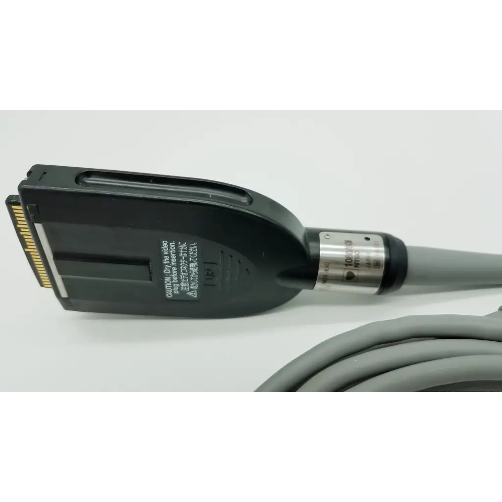 Black plastic connector with gold contacts and silver band on gray cable for Olympus OTV-S7ProH autoclavable camera head