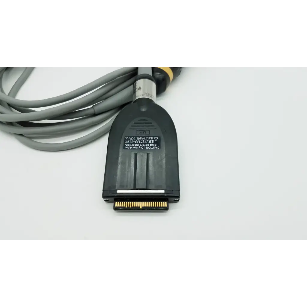 Black plastic connector with gold pins and gray cable on the back side of olympus otv-s7proh-hd-12e autoclavable camera head