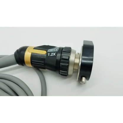 Black and gold autoclavable camera head with 1.2x magnifying lens textured grip and metallic connector attached to gray cable