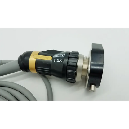 Black and gold olympus otv-s7proh-hd-12e autoclavable camera head with textured grip and metallic connector for hdtv use