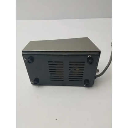 Dark gray rectangular back panel of olympus tokyo tf adjustable lamp power supply with vents and black rubber feet
