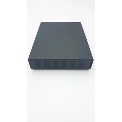 Black rectangular metal olympus vek0n56 ac adaptor with matte finish and ventilation slits along the bottom edge