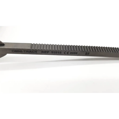 Silver metal kelly retractor blade with textured serrated edge and engraved omni-tract 11515 markings