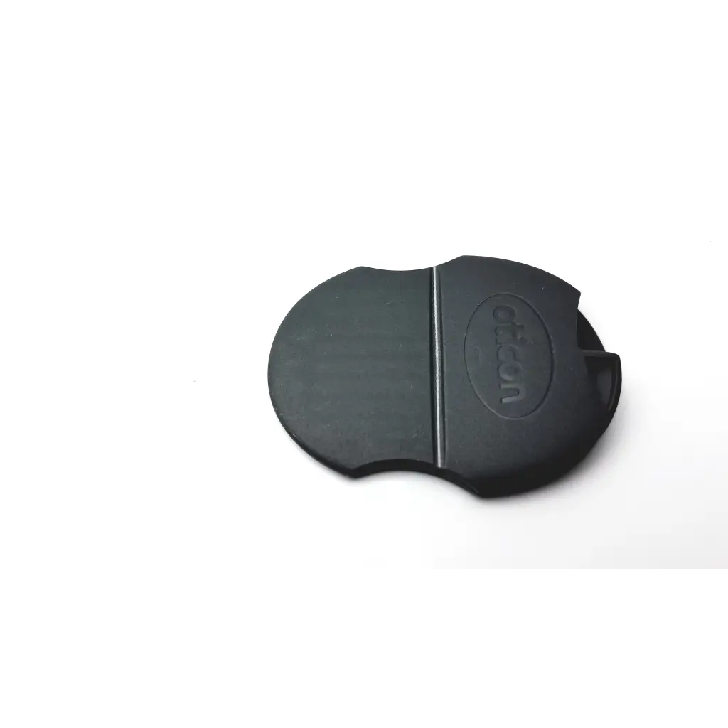 Black rubber lens cap with canon logo embossed, smooth matte finish, compatible with oticon t-cap hearing aids mid brown cover