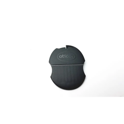 Black oticon t-cap microphone cover with a matte finish and oval design for hearing aids in mid brown