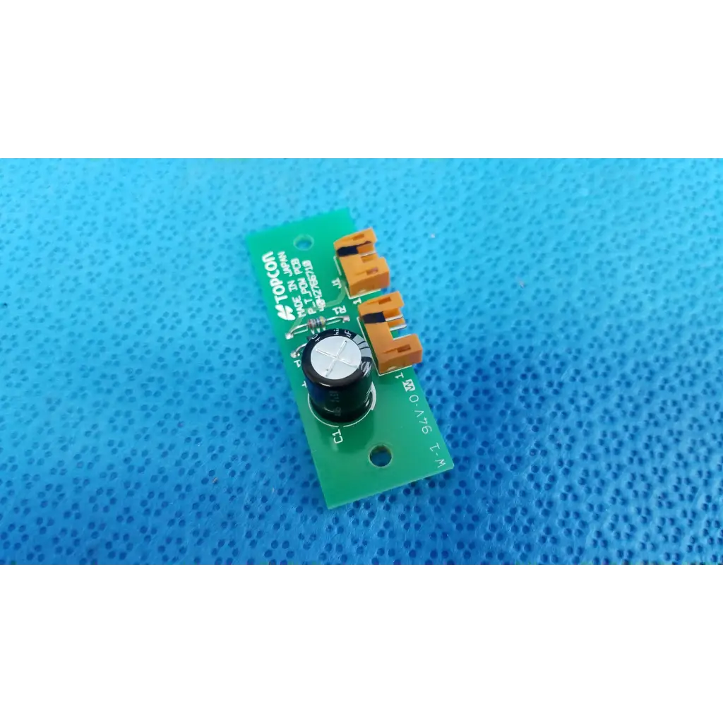 Green pow pcb power circuit board with orange connectors and black cylindrical component for retinal camera use