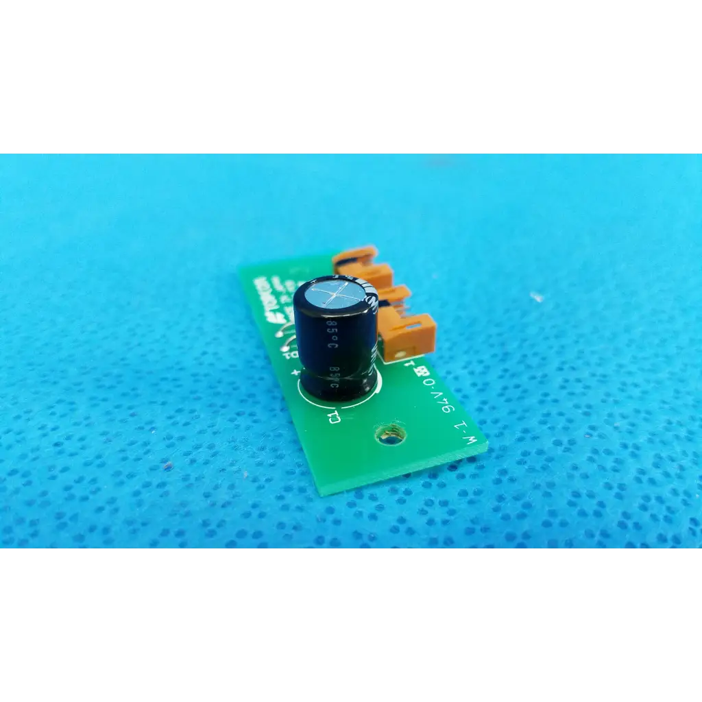 Black cylindrical capacitor on green pow pcb power circuit board with orange terminals for topcon retinal camera