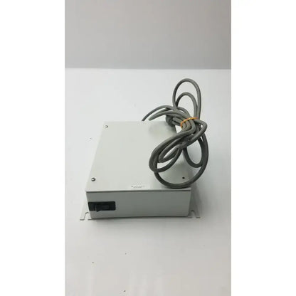 Gray metal isolation transformer offset controller with coiled gray cable secured by yellow tie part no 11970-0000-01
