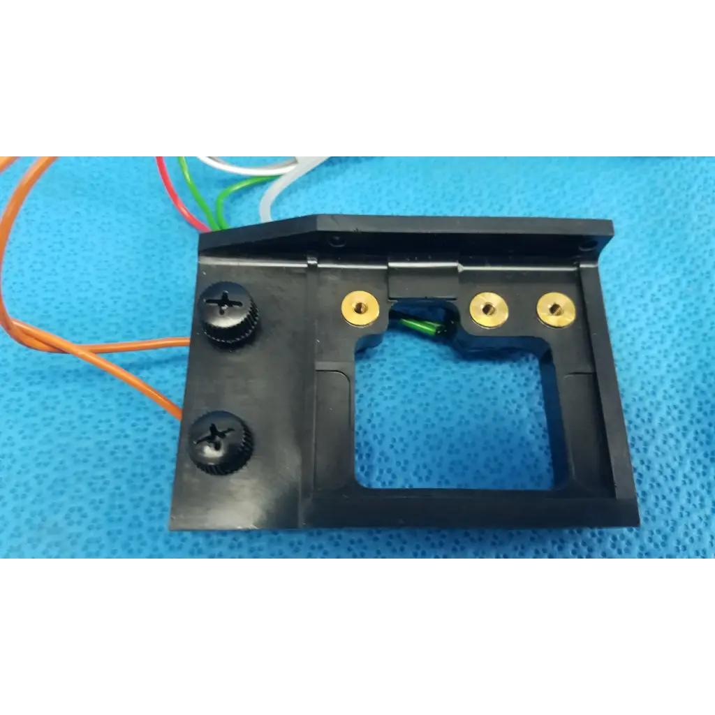 Black plastic harness assembly housing with gold screw holes and rectangular cutout for trc-nw6s circuit board