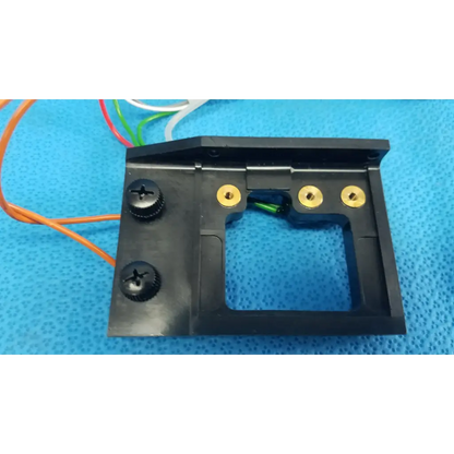 Black plastic harness assembly housing with gold screw holes and rectangular cutout for trc-nw6s circuit board
