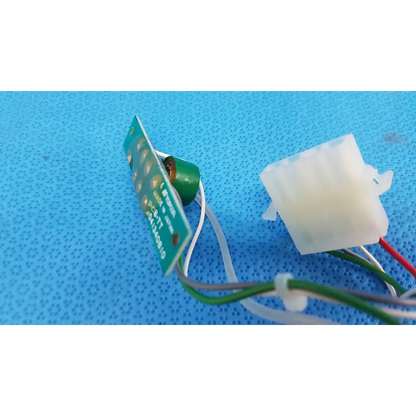 Green circuit board harness assembly with white and red wires connected to a translucent connector for trc-nw6s retinal camera