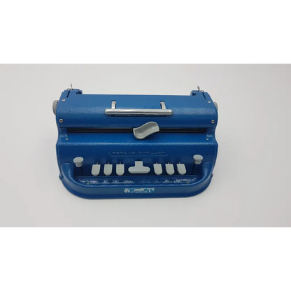 Blue mechanical perkins brailler aph light-touch brailler with silver accents and white keys for braille writing