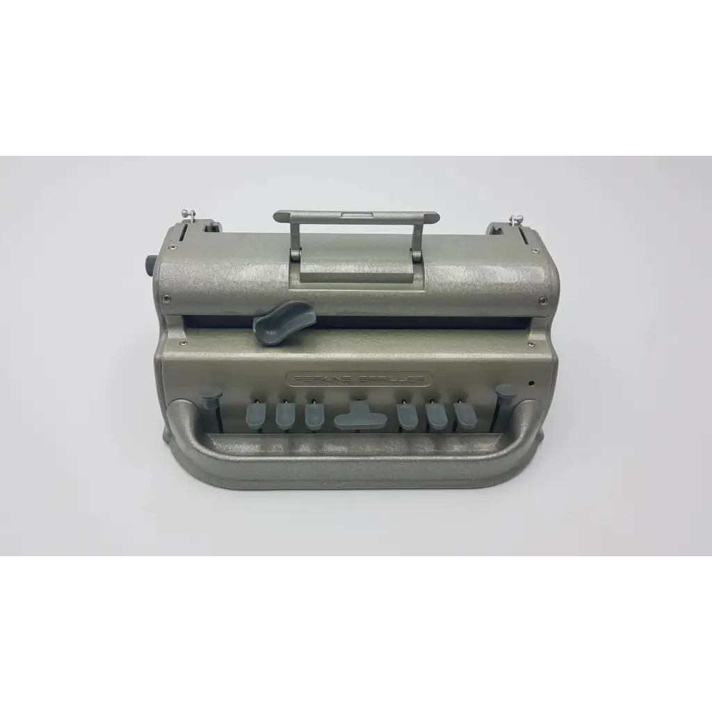 Gray metallic perkins classic brailler with sturdy handle and multiple key levers designed for braille typing