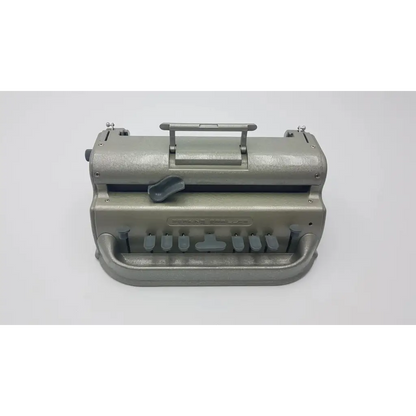 Gray metallic perkins classic brailler with sturdy handle and multiple key levers designed for braille typing