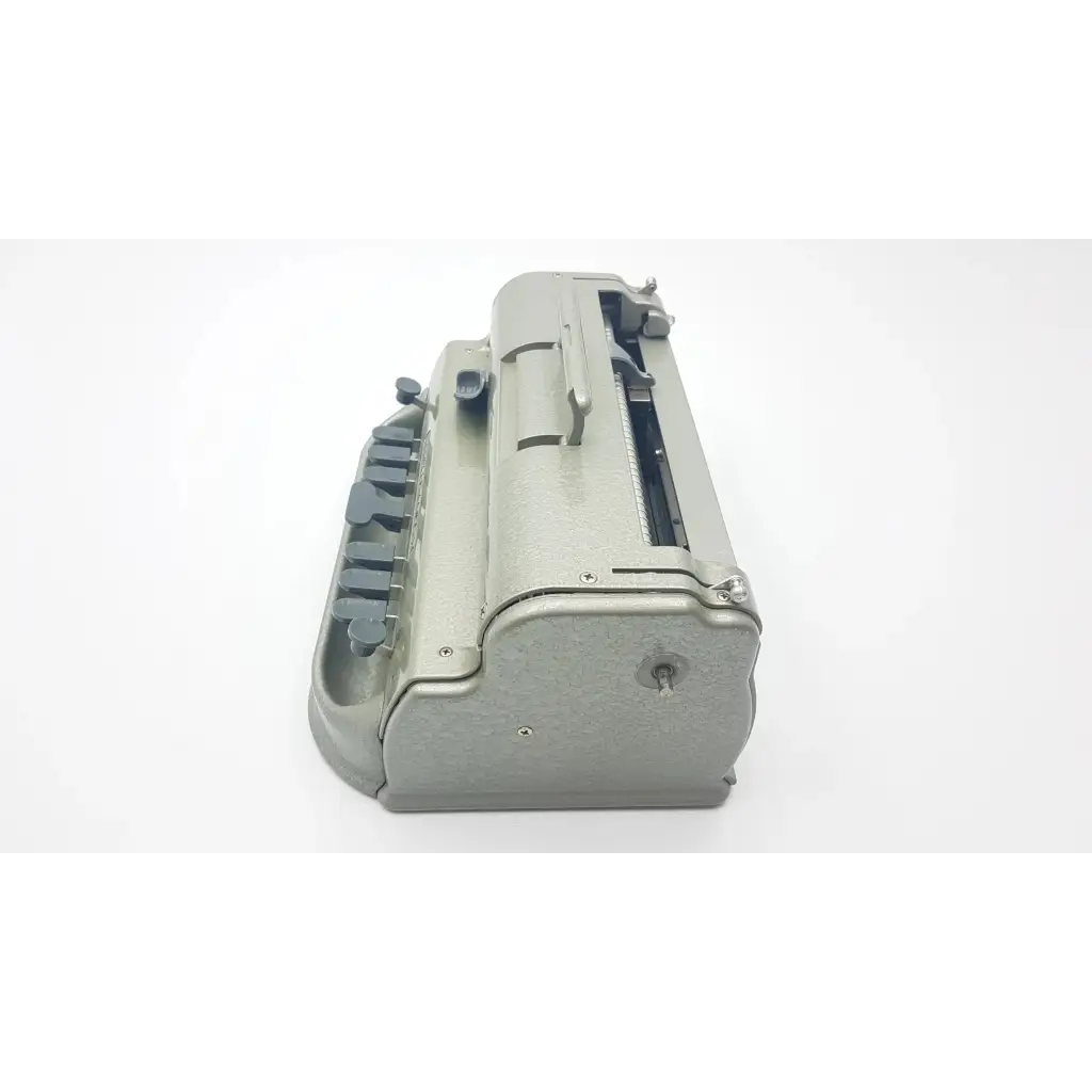 Gray metal perkins classic brailler with sturdy vintage design and black keys for braille writing by the blind