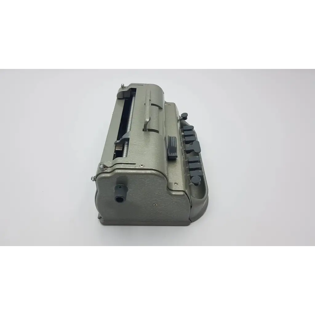 Gray metallic military-style typewriter with black keys and sturdy design in the perkins classic brailler for blind