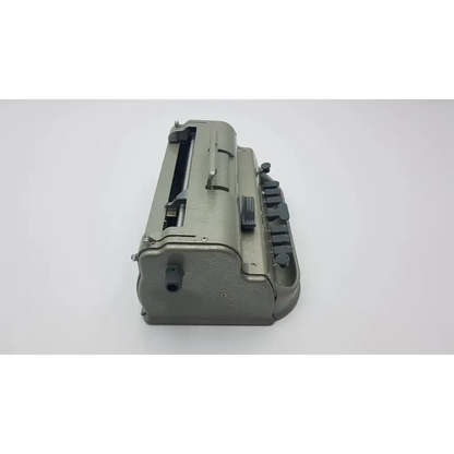 Gray metallic military-style typewriter with black keys and sturdy design in the perkins classic brailler for blind