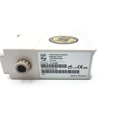 White rectangular philips m1002b ecg respiratory module with textured circular port and made in germany label on back side