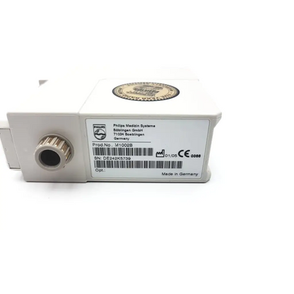 White rectangular philips m1002b ecg respiratory module with metallic port label showing product and serial numbers