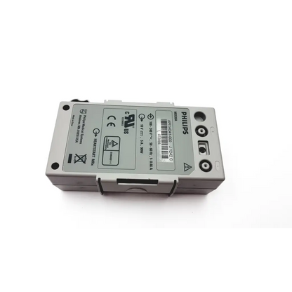 Gray philips m3539a heartstart defibrillator battery with black circular connectors and technical specification label