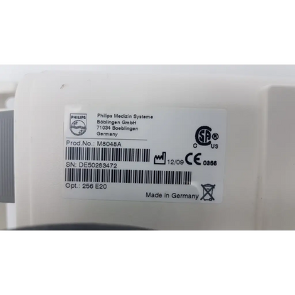 White plastic medical device label with black printed text and philips branding on philips m8048a healthcare module rack