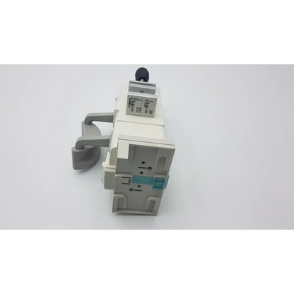 Gray plastic industrial air valve with black knob and teal component on philips m8048a healthcare module rack