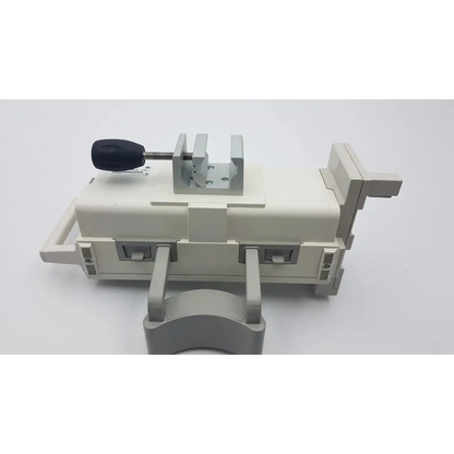 Beige plastic cable management clamp with black adjustment screw and metal brackets on philips m8048a healthcare module rack