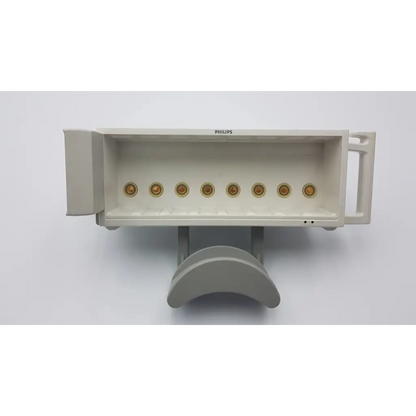 Beige philips m8048a healthcare module rack with six gold circular connectors on front panel for medical use