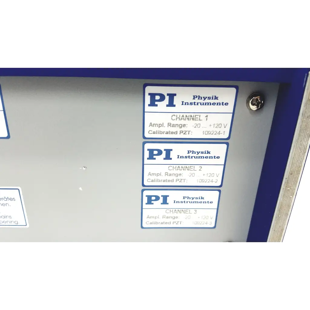 Gray metal panel with three blue and white pi physik instrumente labels showing calibrated lvpzt amplifier channels for servo controller