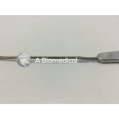 Silver stainless steel spatula retractor adult left with rounded handle and flat slightly curved blade for surgical use
