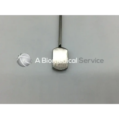 A sleek metallic stamey needle ac5-295 with a slender shaft and rectangular head engraved with number 214638