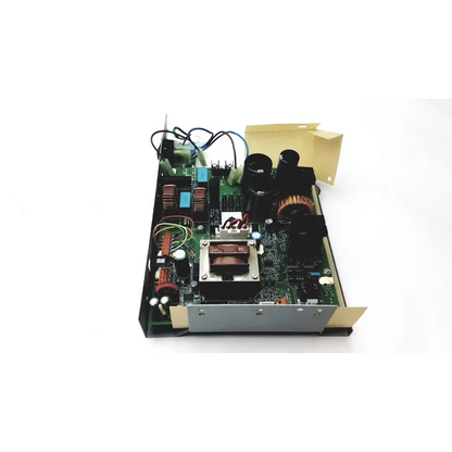 Green circuit board with black capacitors copper windings and blue components inside metallic housing of planmeca intra psu2
