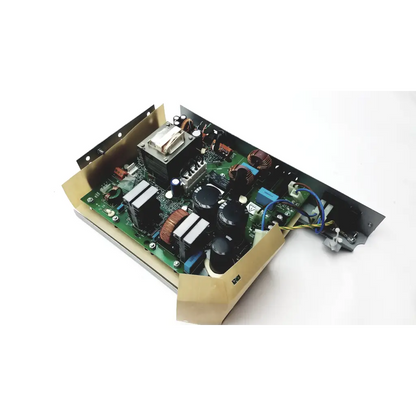 Green circuit board with black capacitors and copper windings on metal chassis in planmeca intra psu2 product back side