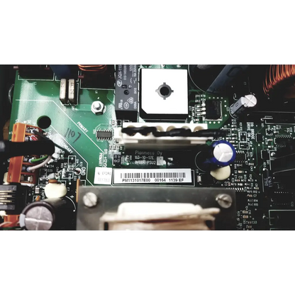 Green circuit board with black and white components and barcode label in planmeca intra psu2 product back side