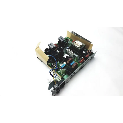 Green circuit board with capacitors wires and metal components mounted on silver chassis of planmeca intra psu2 OY 113-10-17E