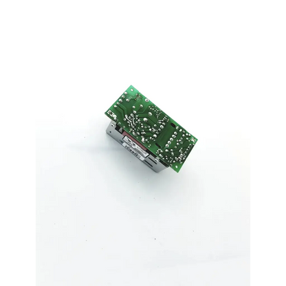 Green printed circuit board with silver solder points and metallic housing of power condor power supply 15vdc input 100-240v