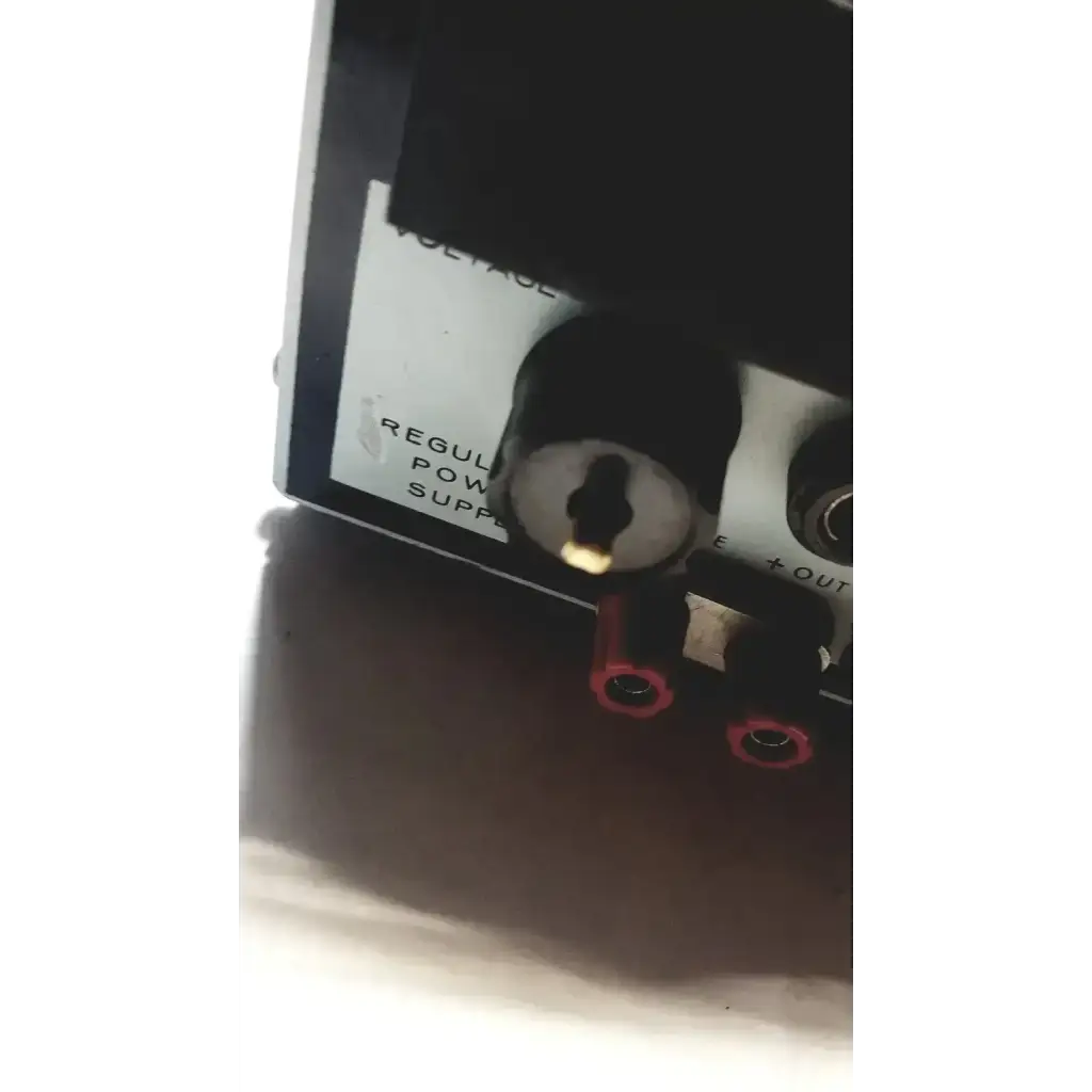 Black power supply unit with silver keyhole and red terminal connectors by power mate corp for 105-125v use